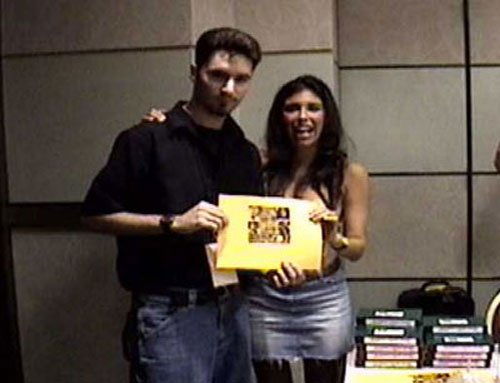 Felissa and Jeff hold a mini poster...
