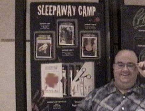 Anchor Bay's super-cool Michael Felsher stands beside a poster for the SURVIVAL KIT displayed at the convention.