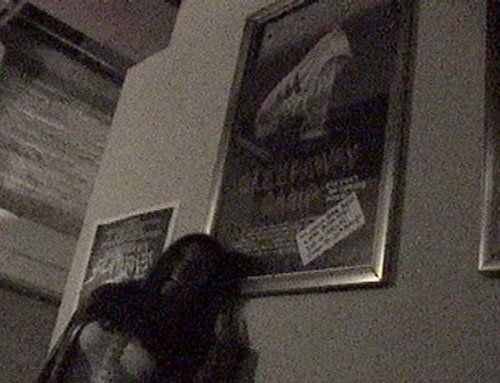 Felissa stands in front of a cult classic in the lobby of the ALAMO DRAFTHOUSE.