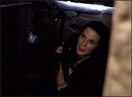 Desiree Gould as Norma holding her cane
