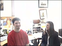 Desiree Gould and Jeff Hayes talking in a production office during Under Surveillance