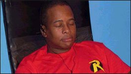 Daryl Wilcher resting in a red shirt on set