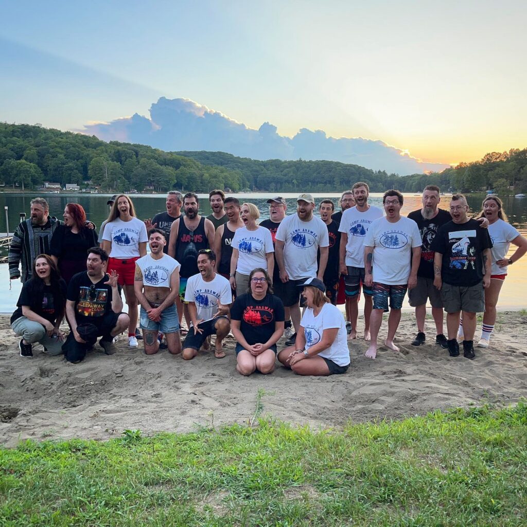 Camp Arawak screening attendees posing by the lake
