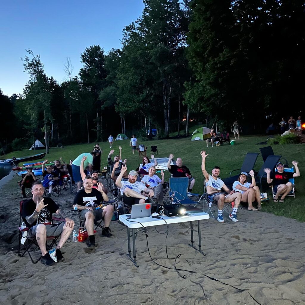 Camp Arawak screening attendees gathered by the lake before the movie