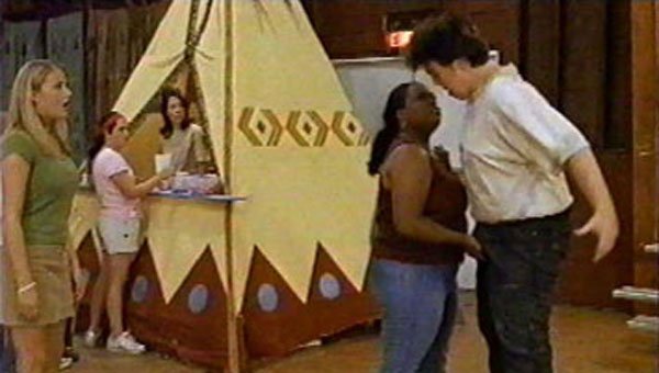 In this scene, camp trouble-maker Alan finds himself in a tight squeeze. It seems that bad-ass Bella, one of Alan's many nemeses at camp, wants to see if she can make him sing soprano! (or maybe that's Vinny Pastore's job?) The two campers find themselves harassing each other constantly with food fights, spitballs, and nasty name-calling contests. What fun would camp be without kids being so mean to each other?? Unfortunately for Alan, the girl of his dreams, Karen, happens to catch his spat with Bella!