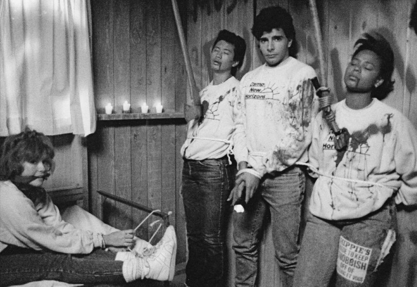 Black-and-white behind-the-scenes photo of three performers posing with staged axe wounds on the Sleepaway Camp III set.